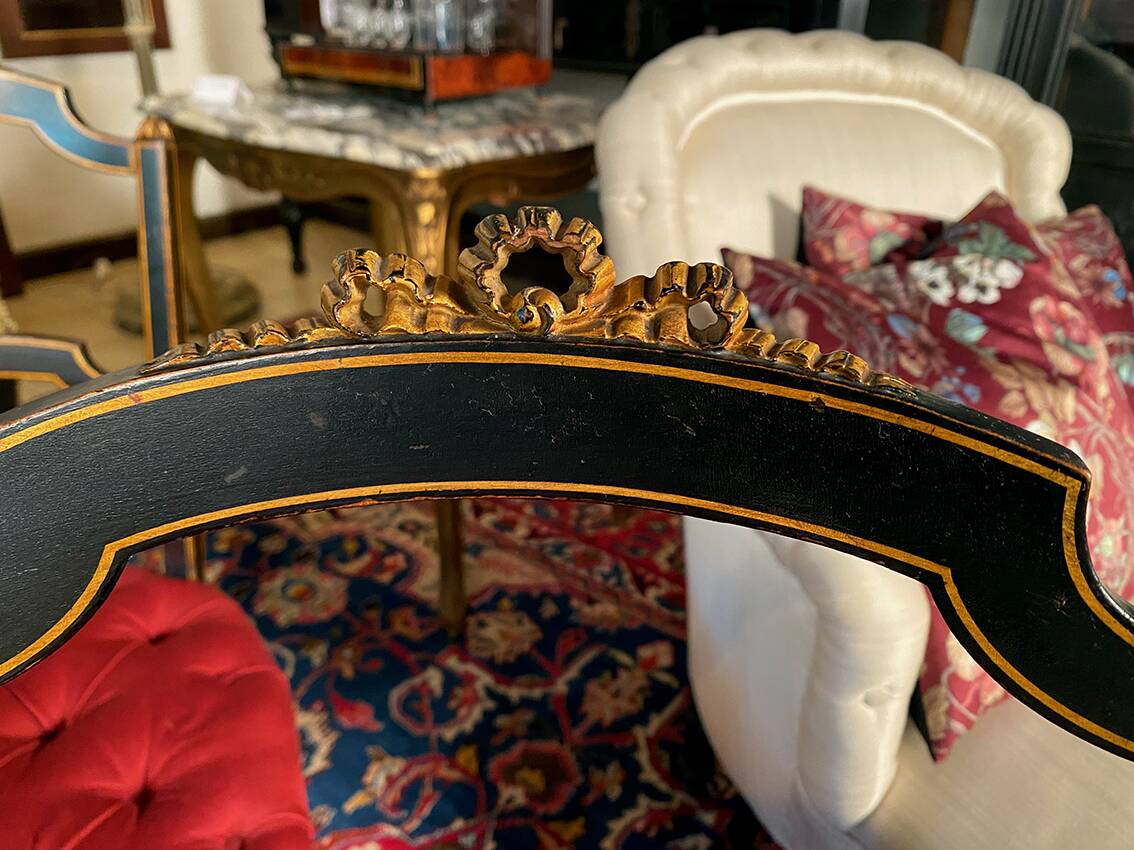 Set of four Napoleon III chairs in black lacquered wood with gold highlights.
