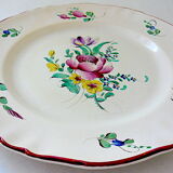 Eastern earthenware plate with floral decoration centered with a rose