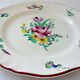 Eastern earthenware plate with floral decoration centered with a rose
