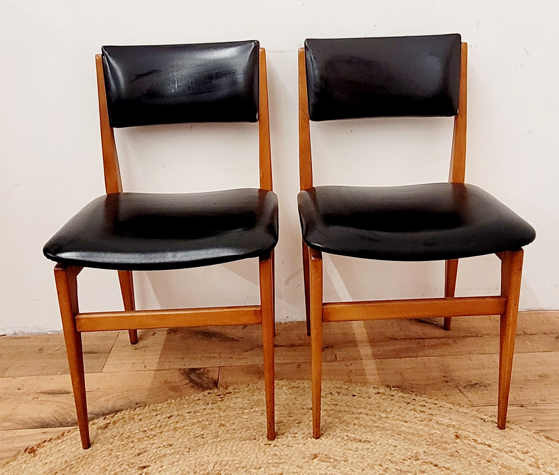 Six vintage wooden chairs and black Skaï