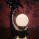 Black ceramic palm lamp and white opaline globe