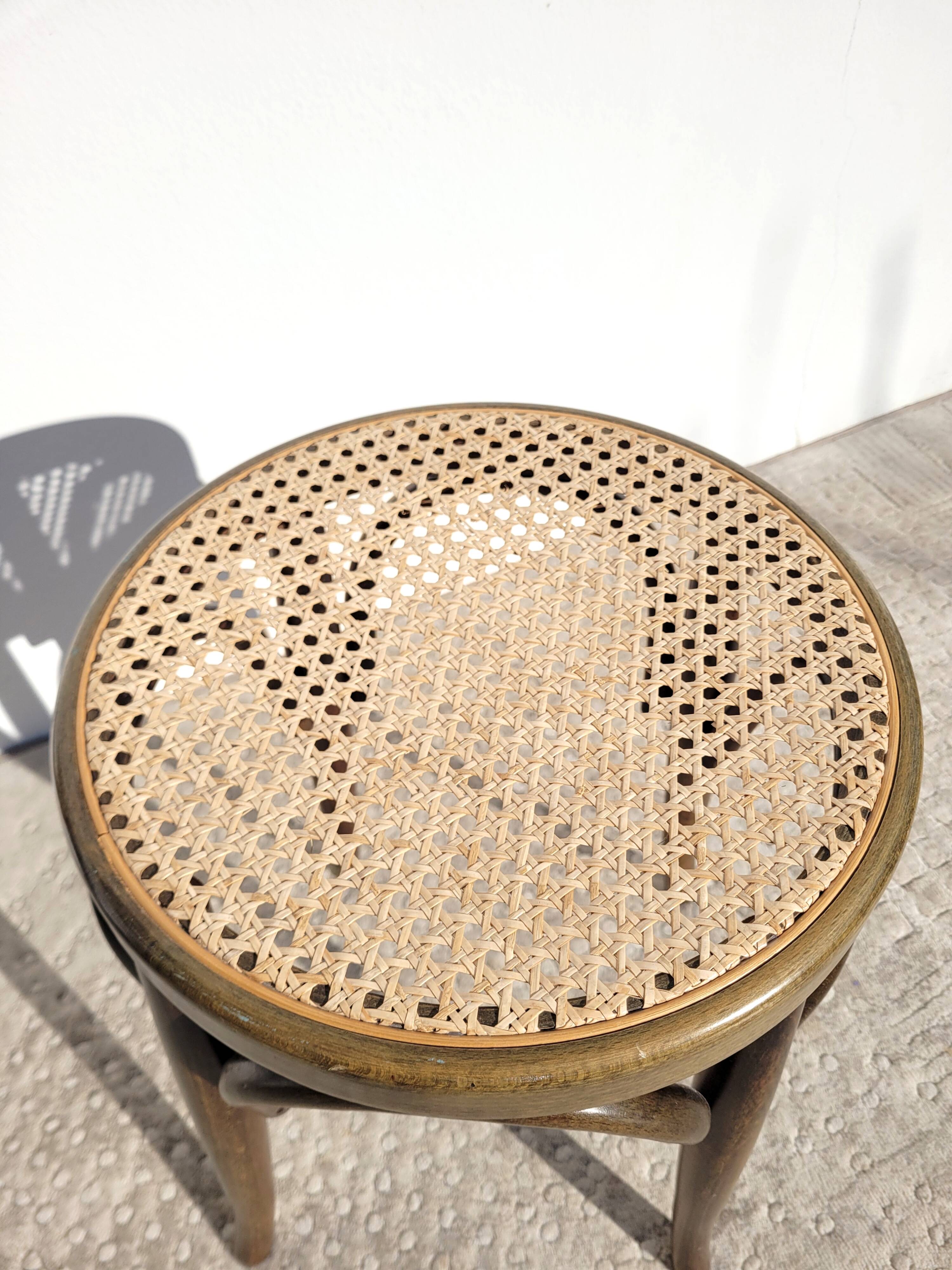 Low stool in cane and curved wood