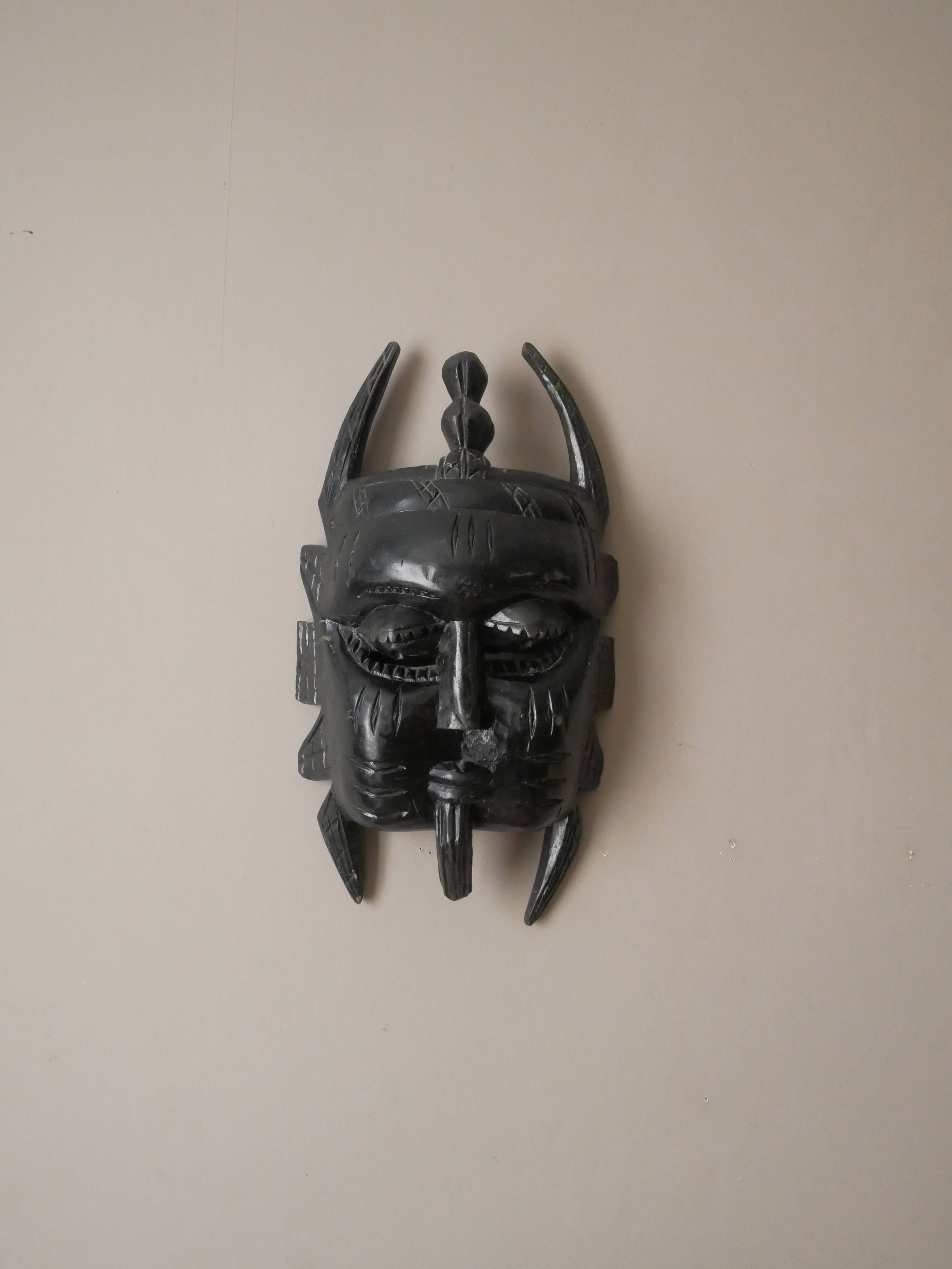 Decorative mask hand carved in tribal ethnic painted wood