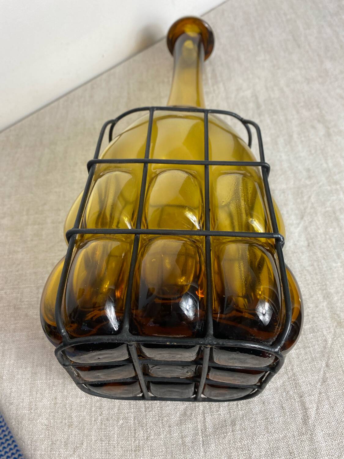 Glass carafe encased in wrought iron