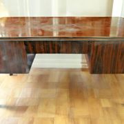 A large Art Deco style rosewood desk with 5 drawers and decorative motifs