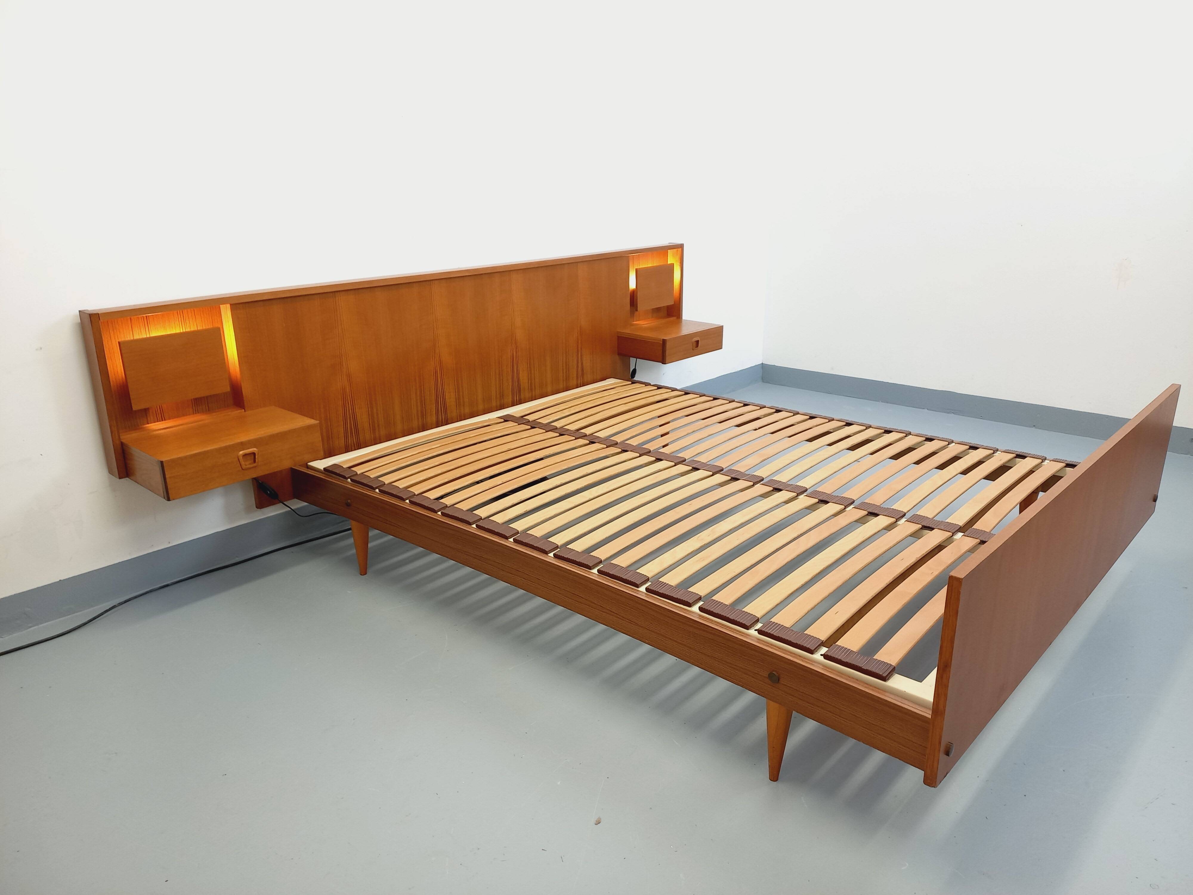 Double bed in vintage Scandinavian style from the 1960s with bedside tables in teak.