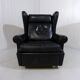 Fauteuil à oreilles en cuir noir sur roulettes années 1960