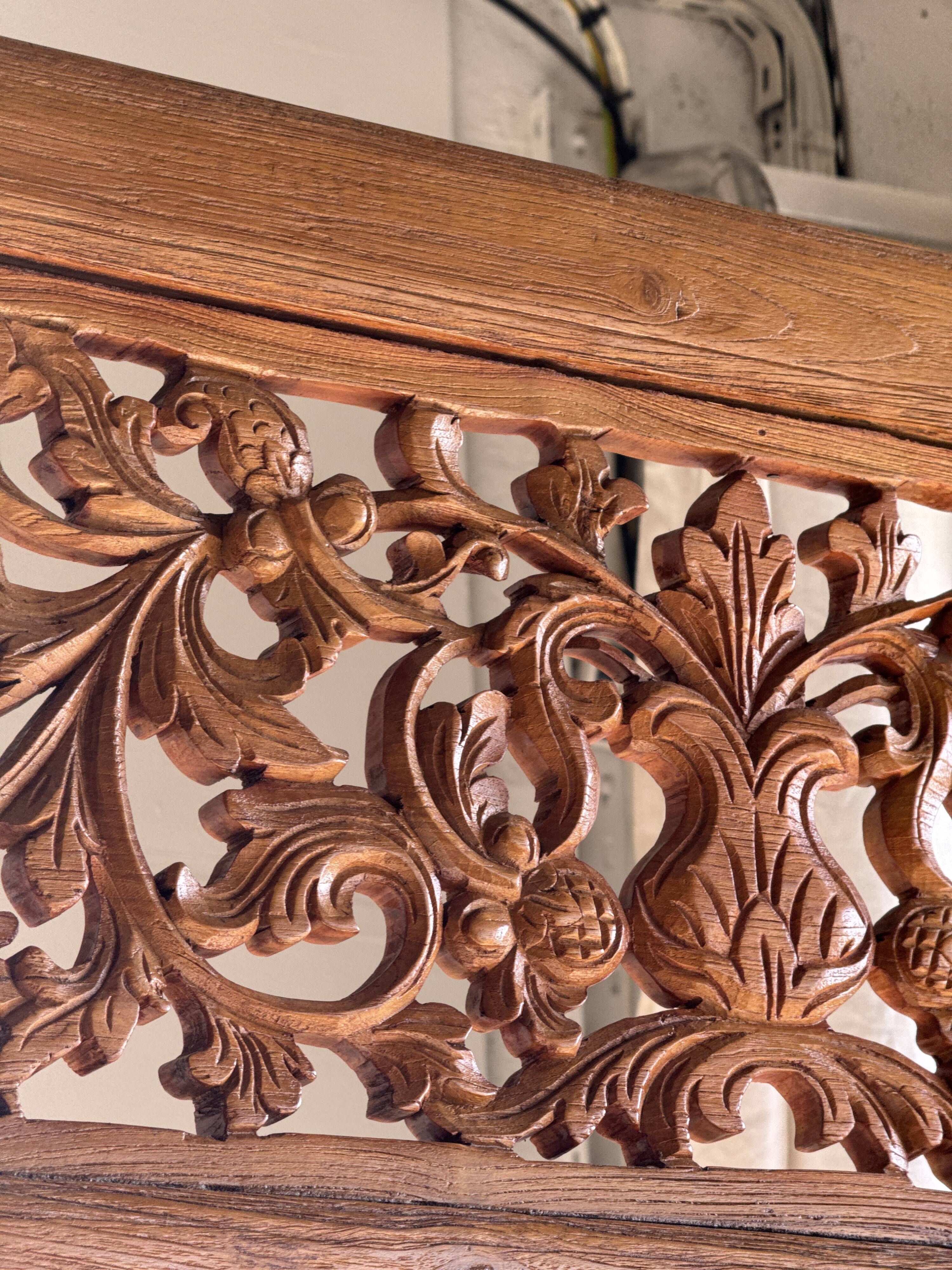Very large freestanding teak mirror with an openwork carved pediment, Indonesia.