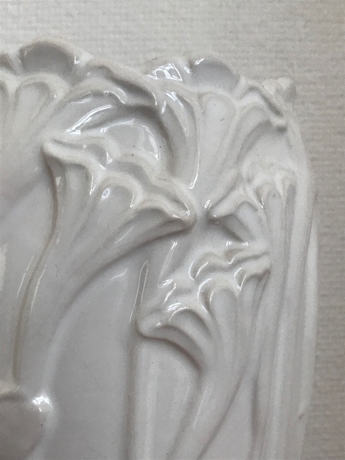 Old white art nouveau vase with flowers and dragonflies