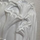 Old white art nouveau vase with flowers and dragonflies