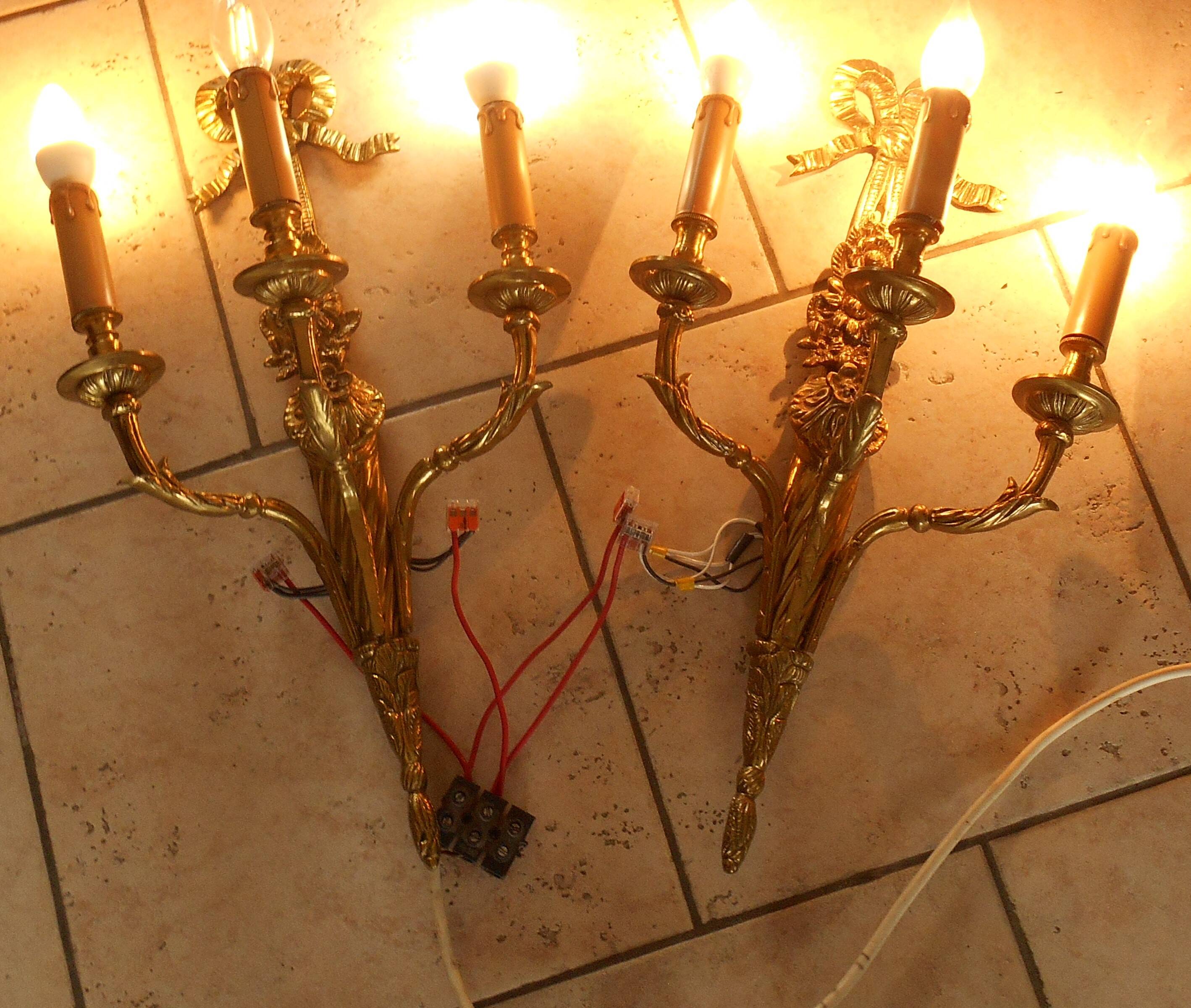 Pair of gilded bronze wall sconces with three lights