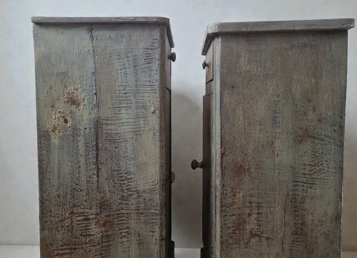 Pair of antique bedside tables with a green patina