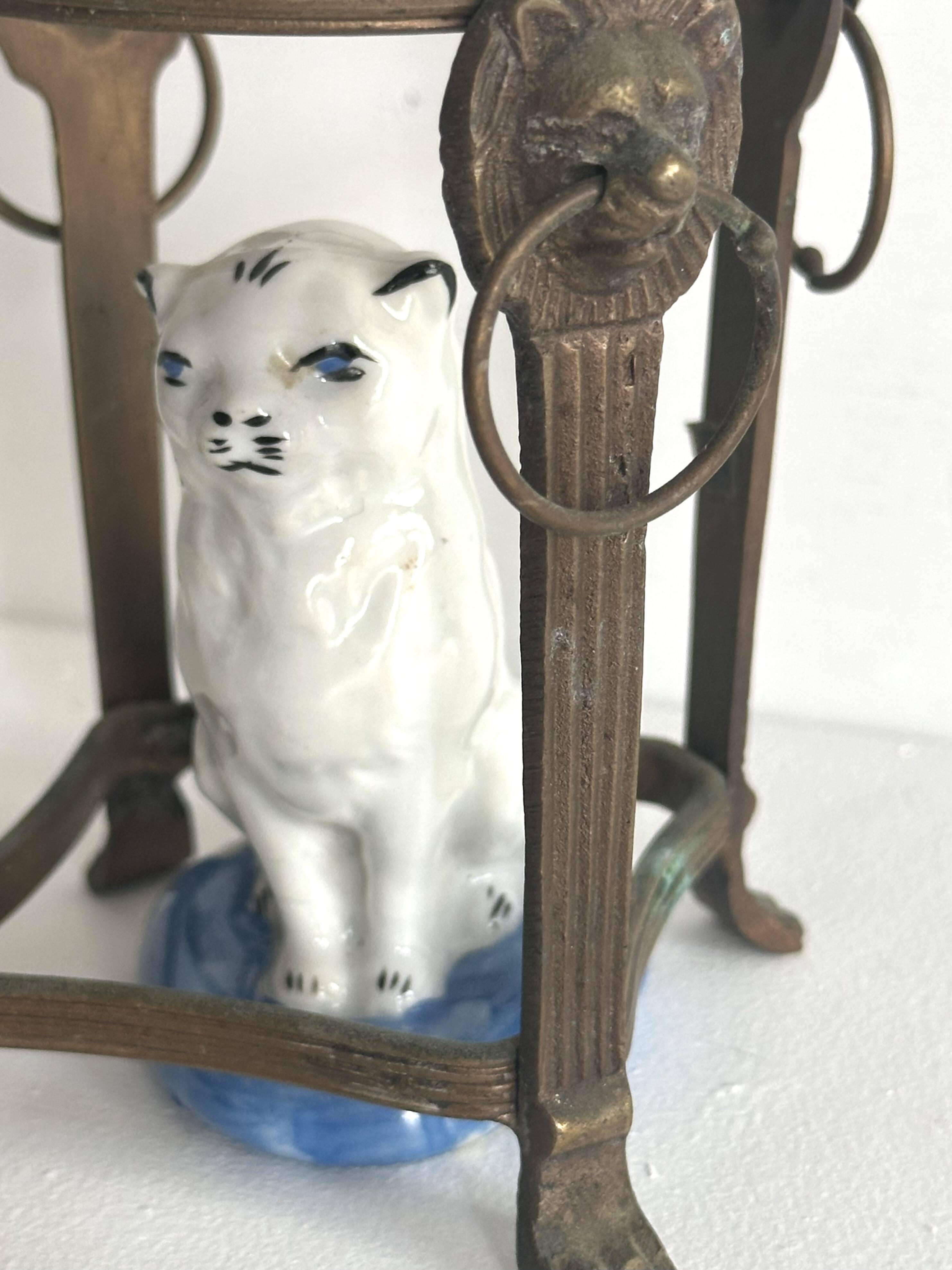 Small ancient glazed ceramic cat from the 19th century.