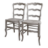 A pair of reimagined country-style chairs in pearl grey.