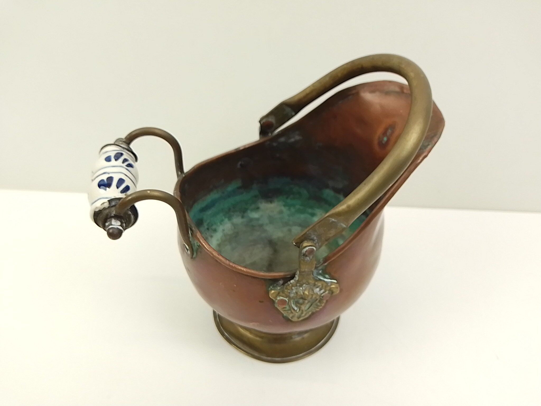 Copper pot cover and a pitcher-style brass handle
