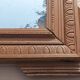Louis XVI mirror in carved wood, 19th century.