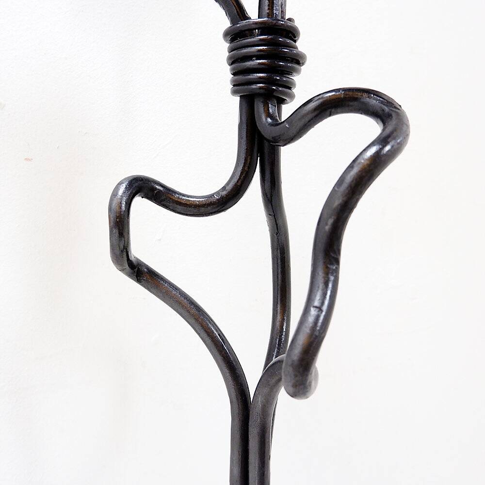 Large wrought iron candelabrum with an abstract design and three candle holders.