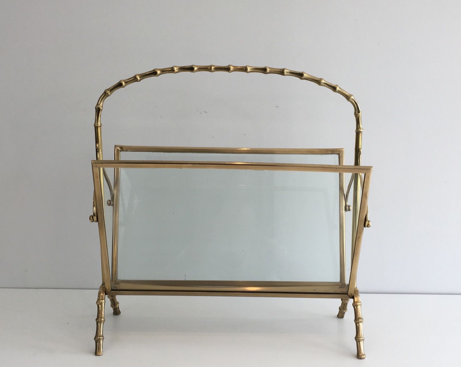 Bamboo-style brass magazine rack from the Baguès house.