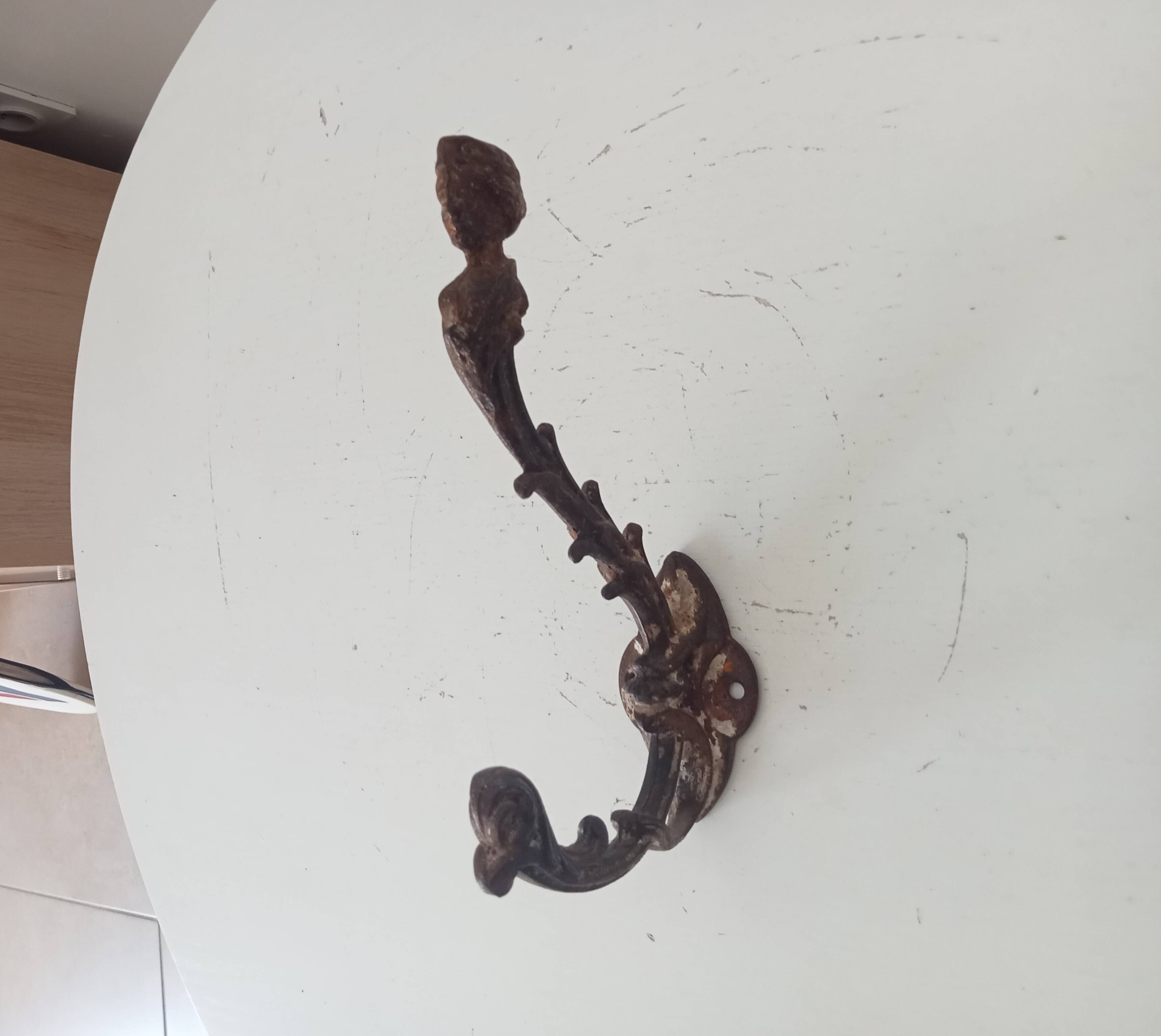 Antique wall coat hook from the 19th century in Victorian cast iron style.