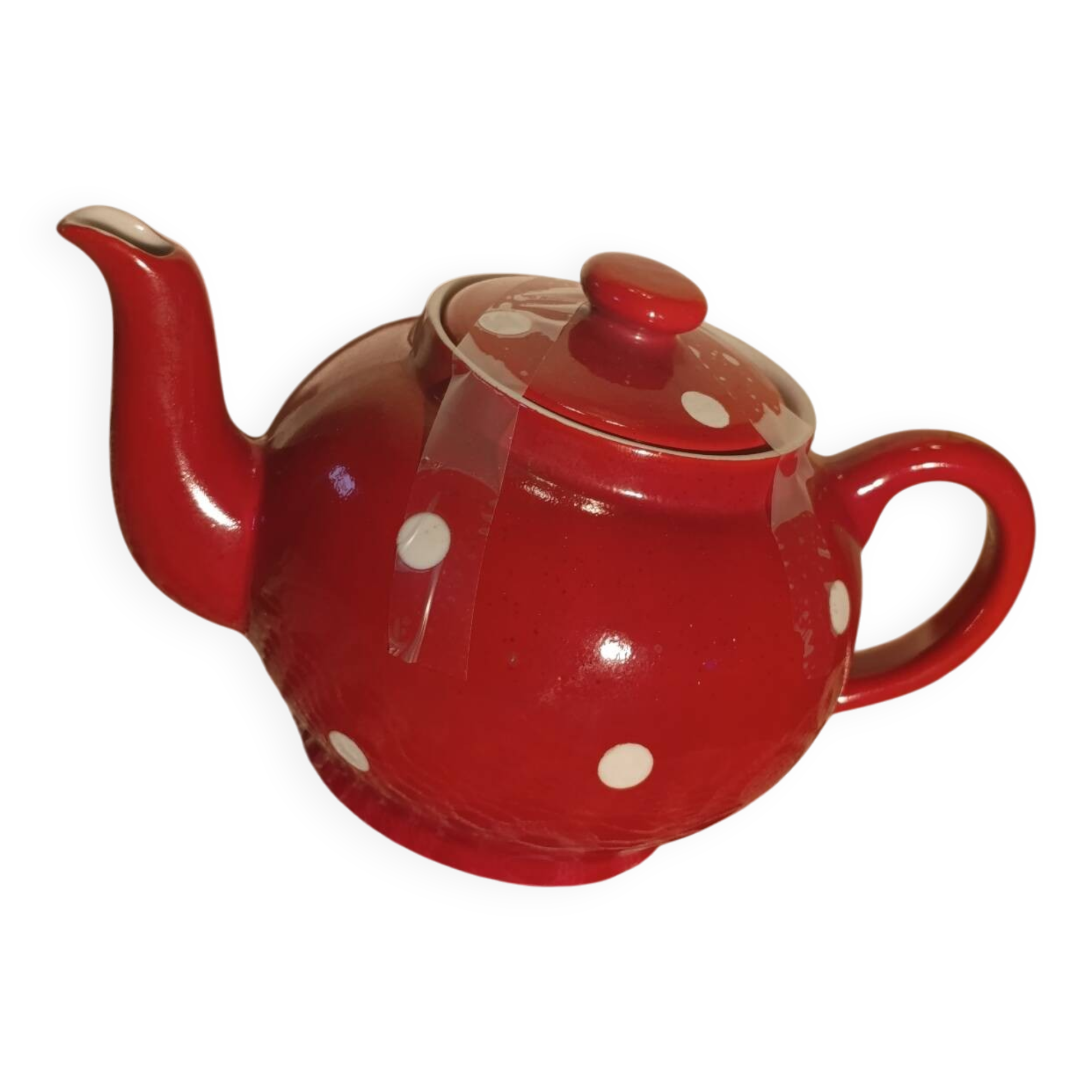 Vintage red teapot with white polka dots.