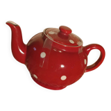 Vintage red teapot with white polka dots.