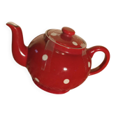Vintage red teapot with white polka dots.
