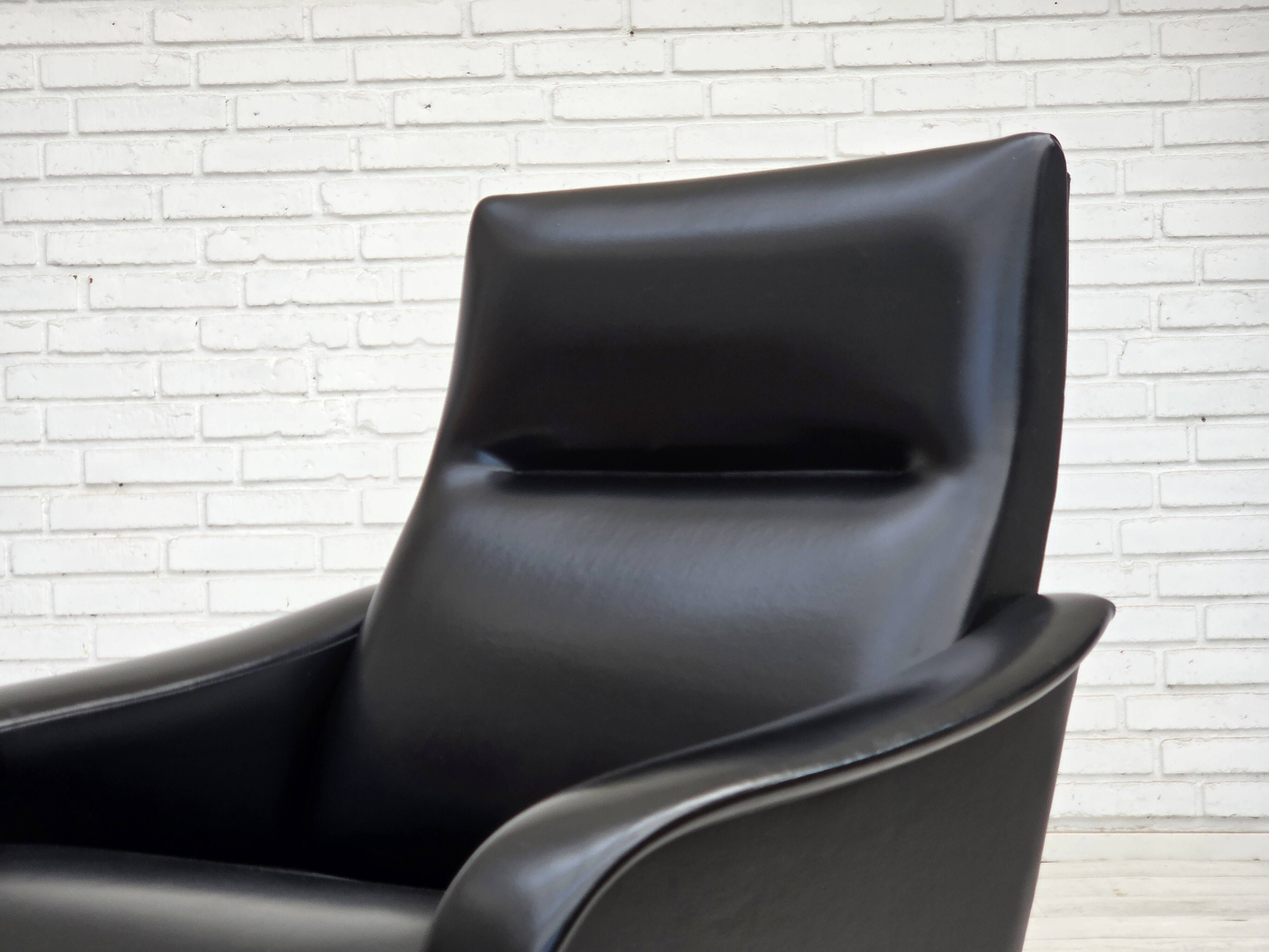 1970s, Danish armchair, black artificial leather, teak wood legs.