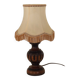 Mid-century French table lamp made of turned carved wood with a fringed shade.