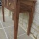 Console in solid walnut with a natural finish, featuring three drawers with a belt.