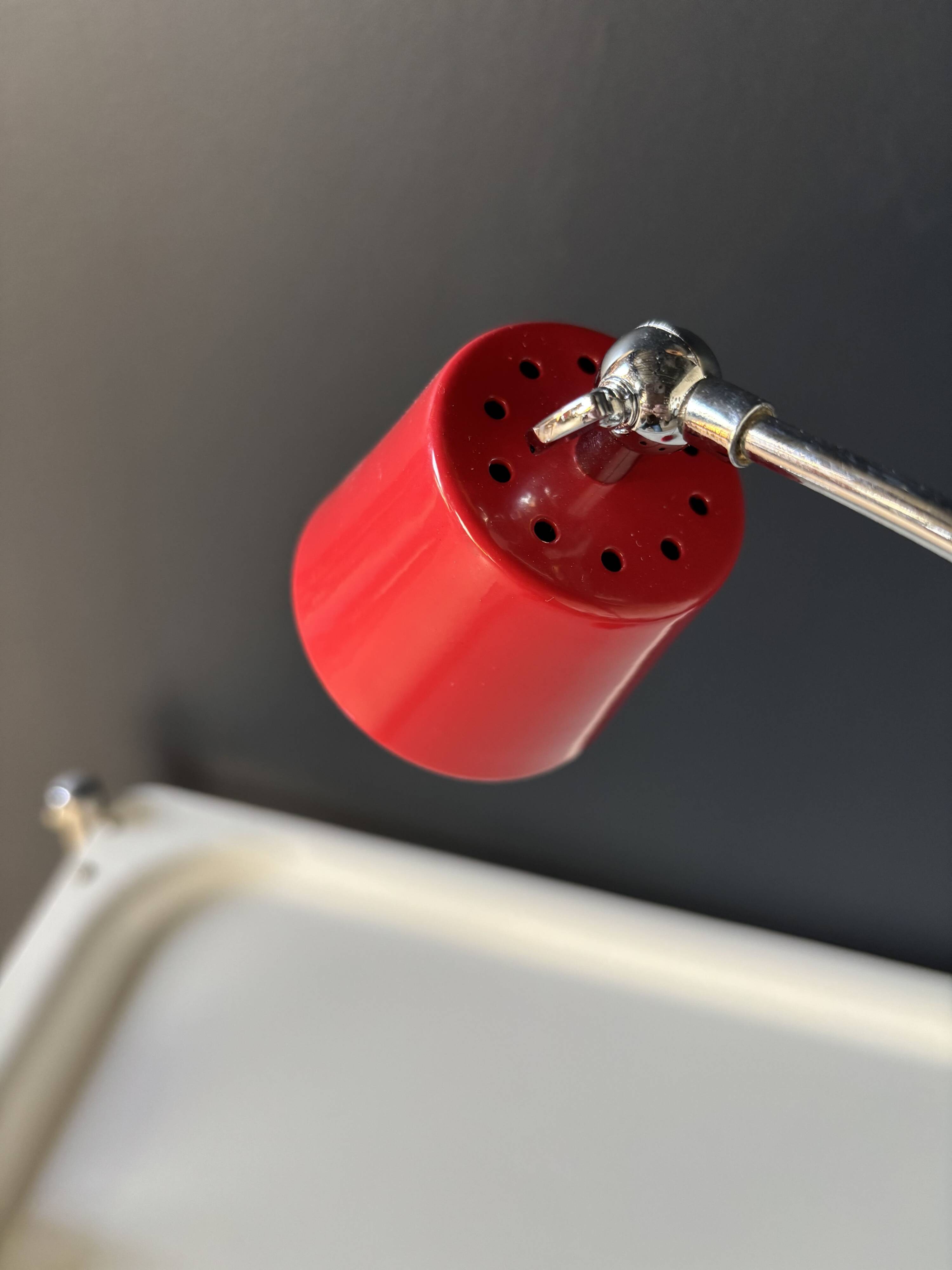 Vintage red lamp with a curved arm