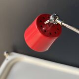 Vintage red lamp with a curved arm