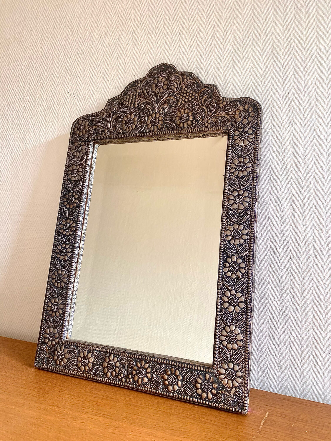 Ancient oriental mirror in embossed copper