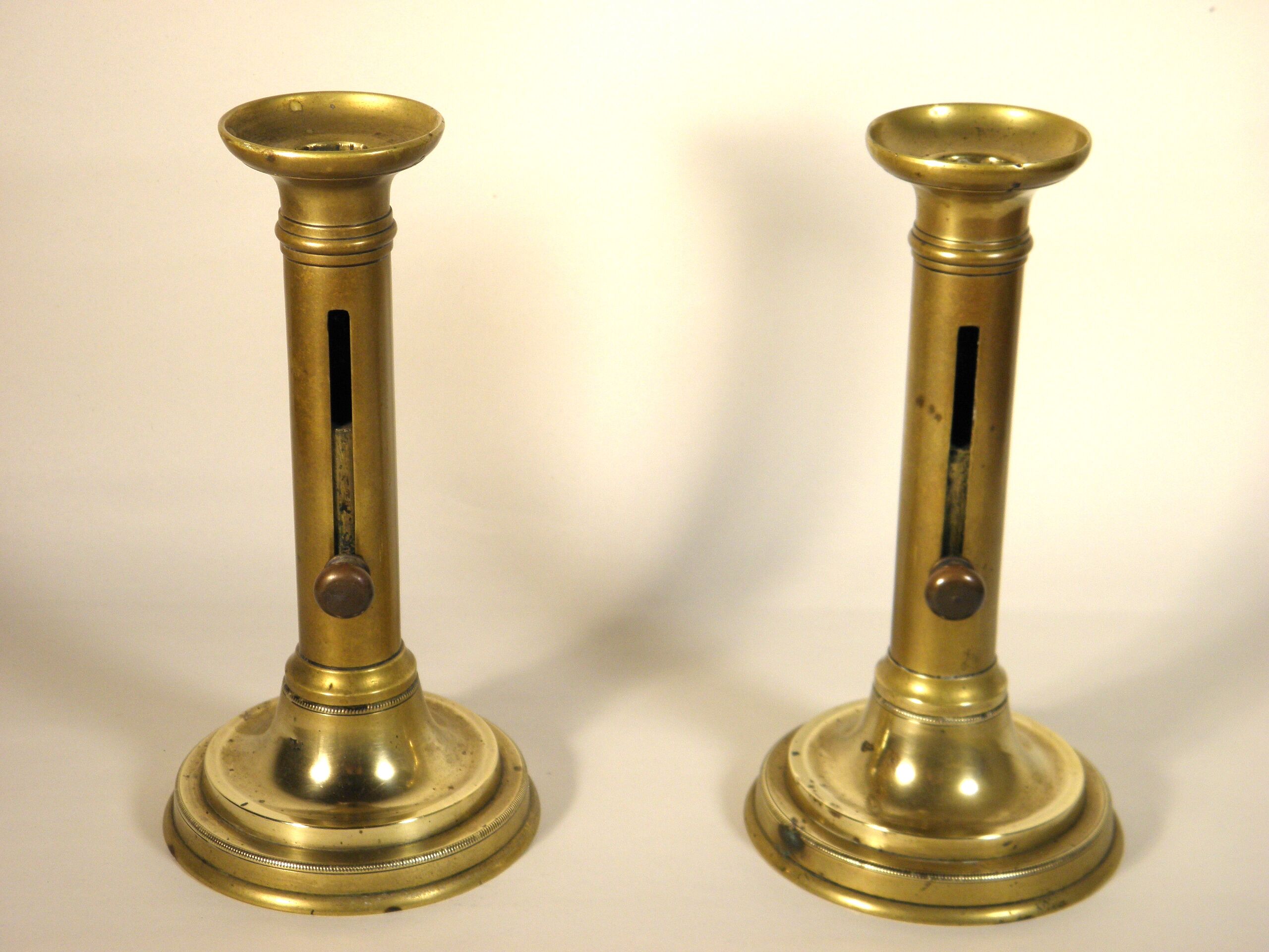 Pair of brass push candlesticks