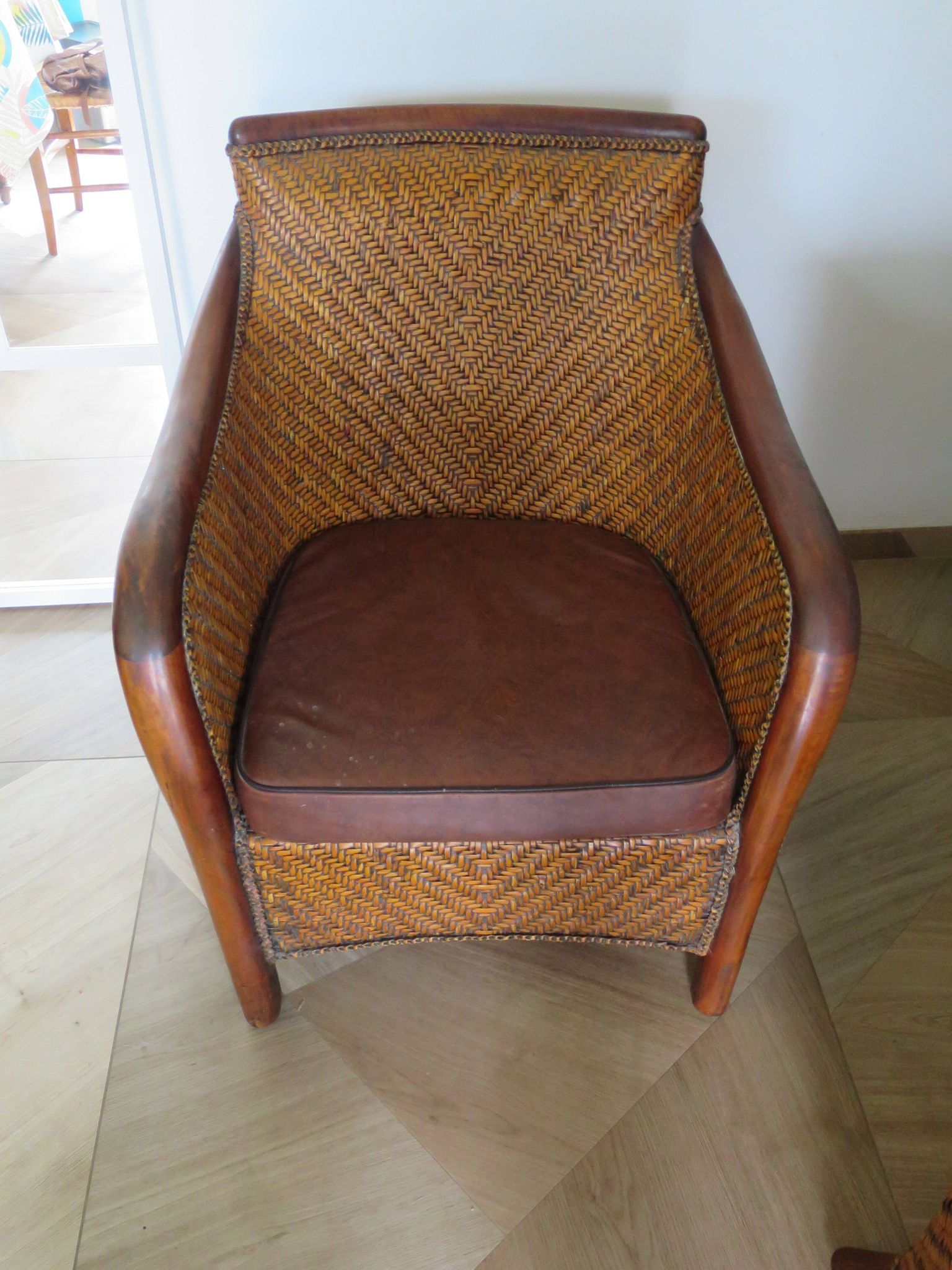 Woven rattan armchair and exotic wood in colonial style, 1980s.