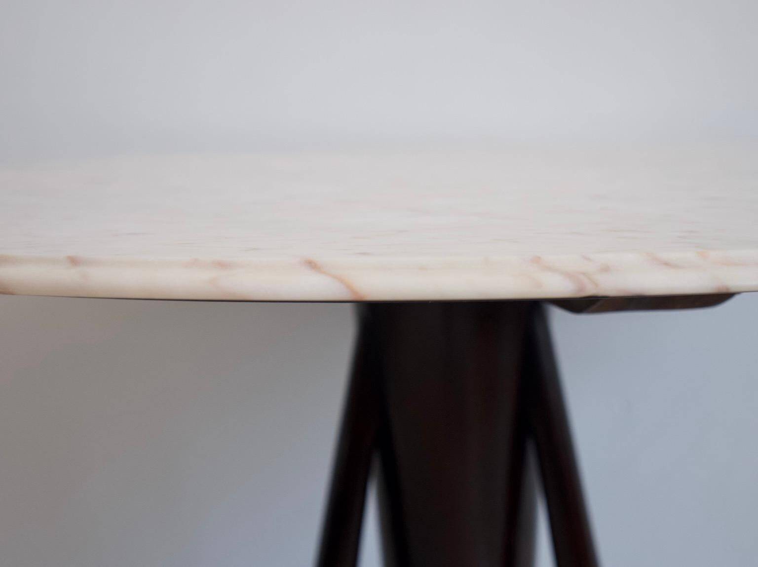 Mid-century modern round dining table in marble and ebony wood.