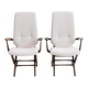 Pair of varnished wooden reclining armchairs, upholstered in lightweight fabric.