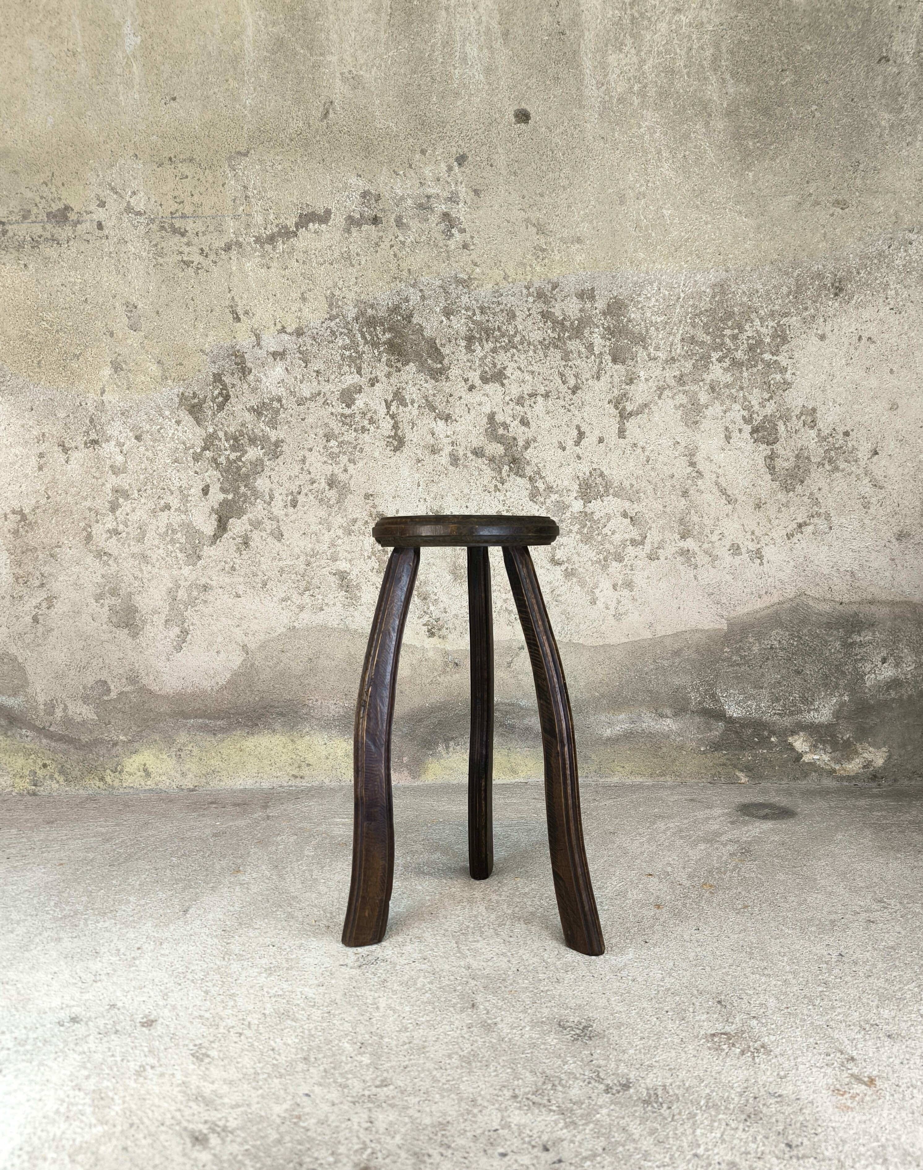 Vintage tripod plant stand with curved legs.