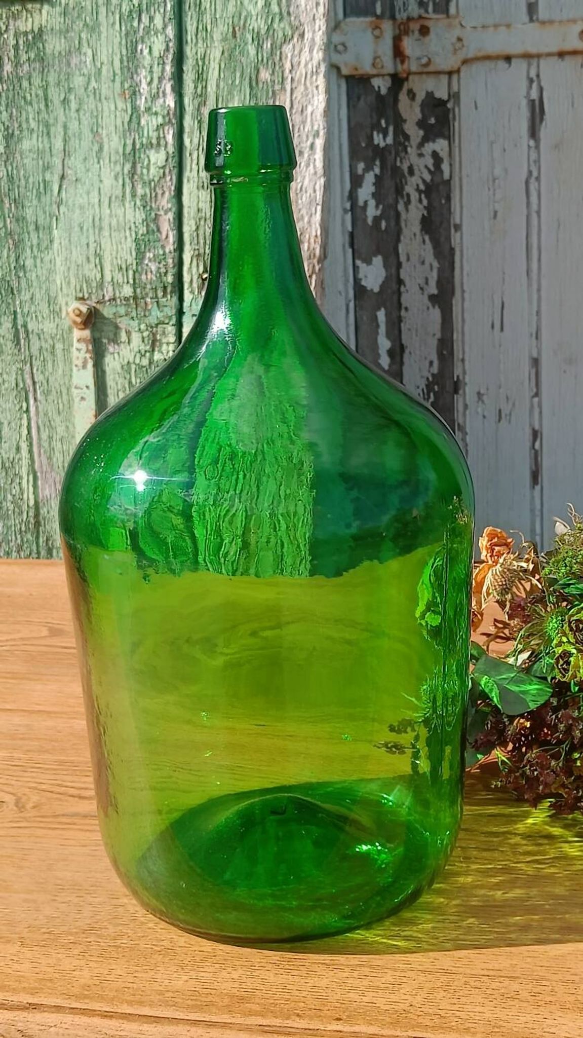 Superb antique green glass demijohn.