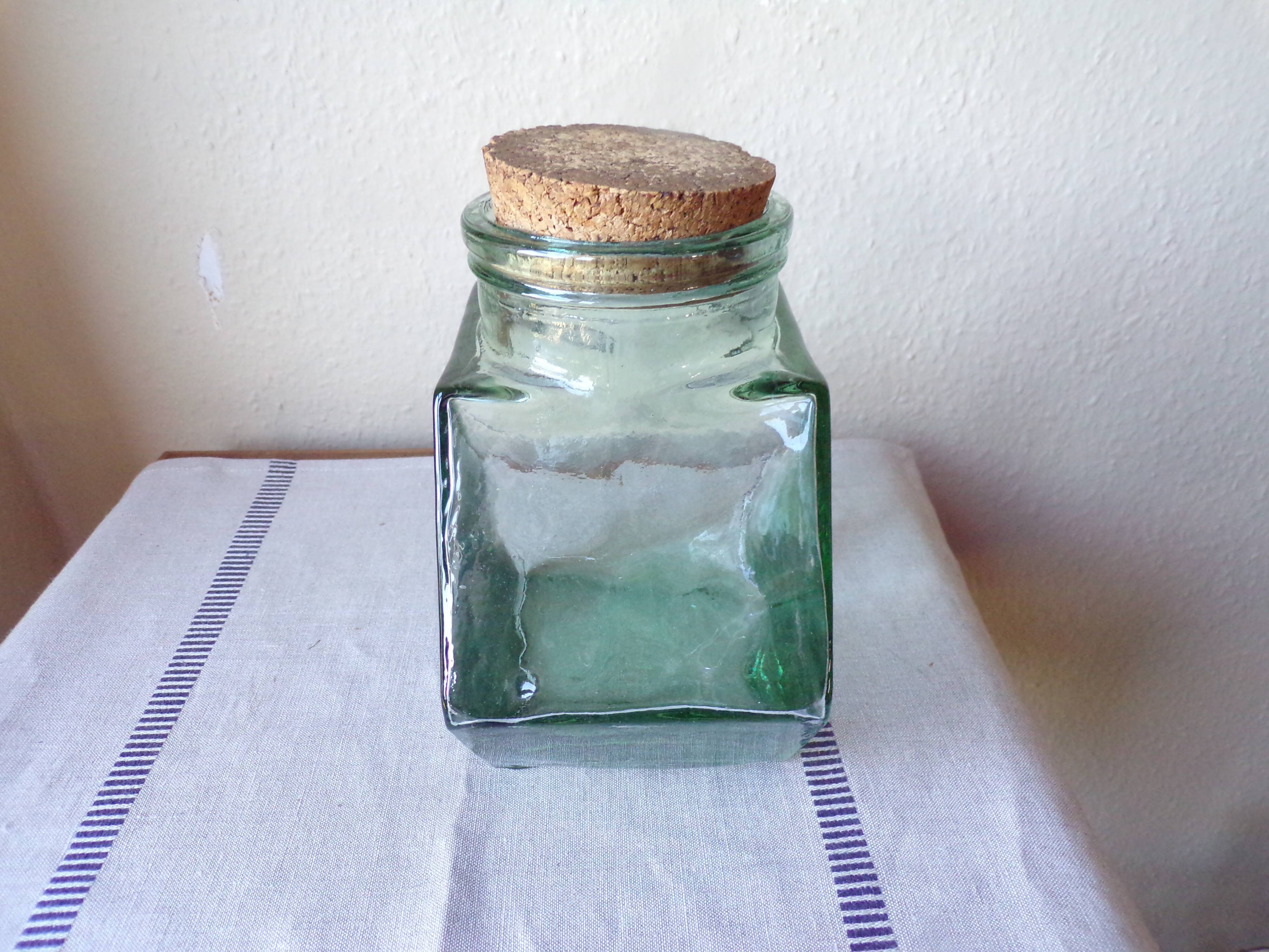Old thick glass of a light green jar