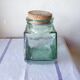 Old thick glass of a light green jar