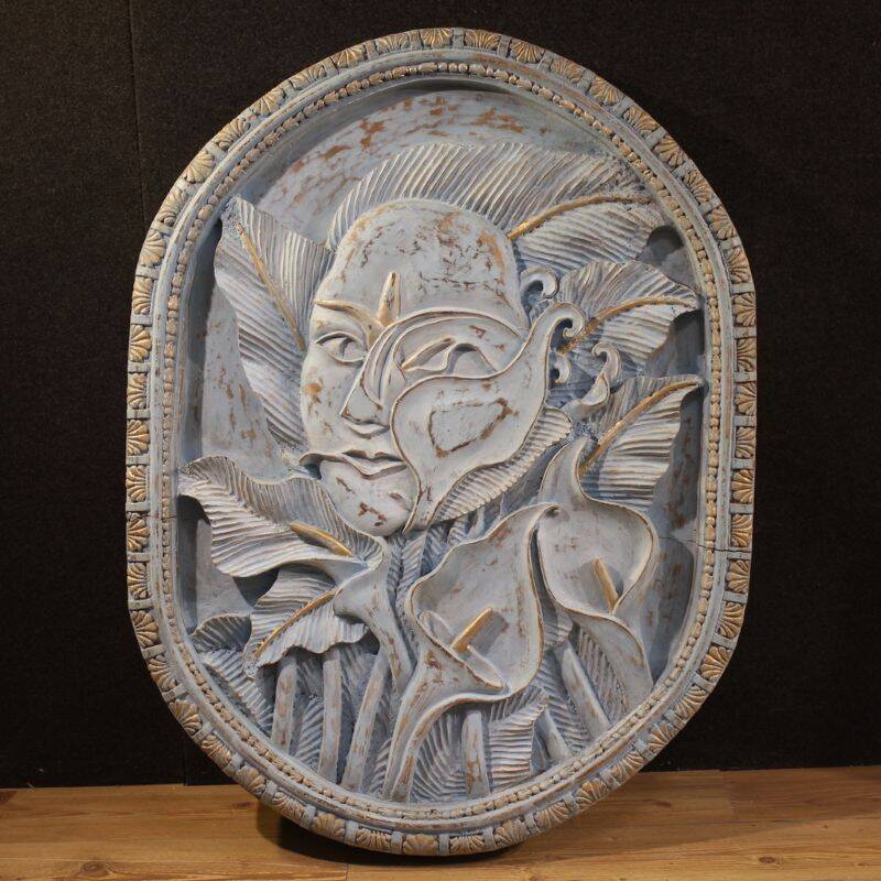 Bas-relief sculpture, stylized face with flowers, 20th century