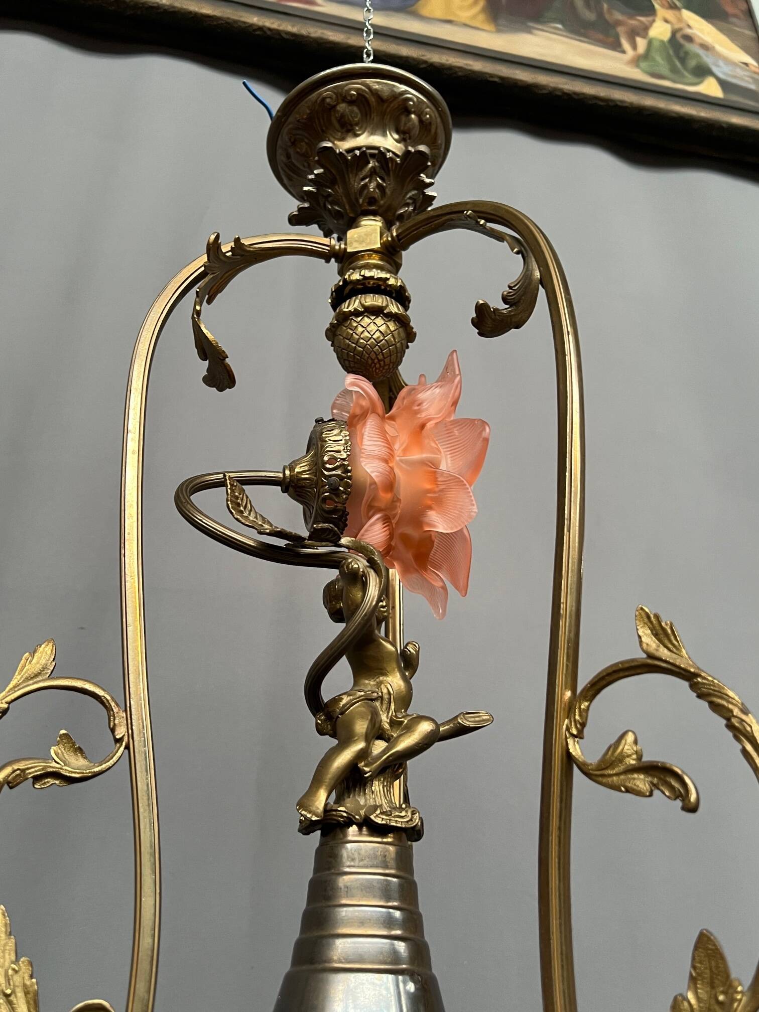Renaissance chandelier with putti statuette.