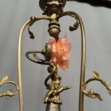 Renaissance chandelier with putti statuette.