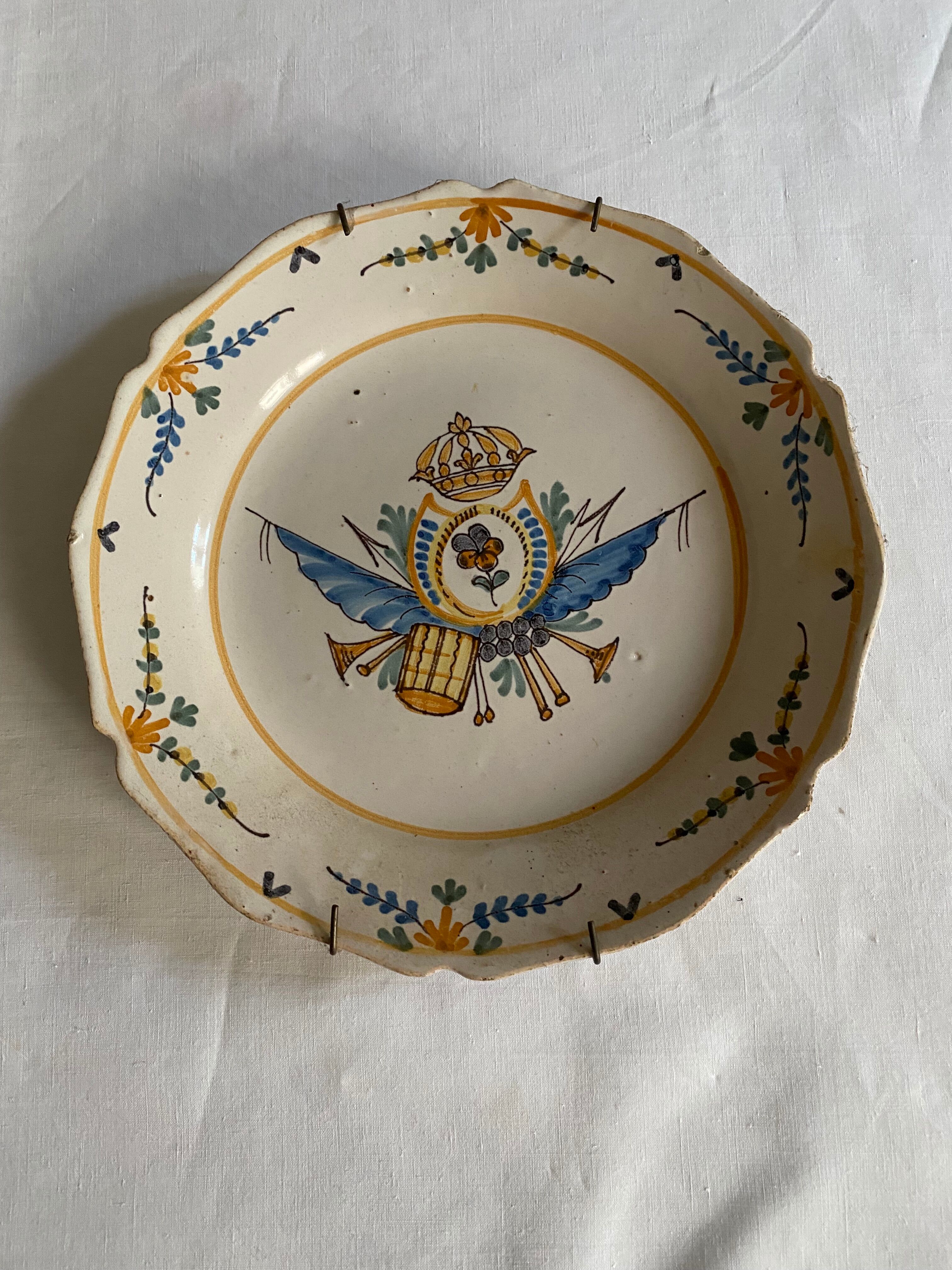 Plate of Nevers in earthenware late eighteenth century decoration of crest to flower