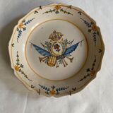 Plate of Nevers in earthenware late eighteenth century decoration of crest to flower