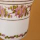 Footed glass in the shape of a chalice in white opaline with a floral decoration.