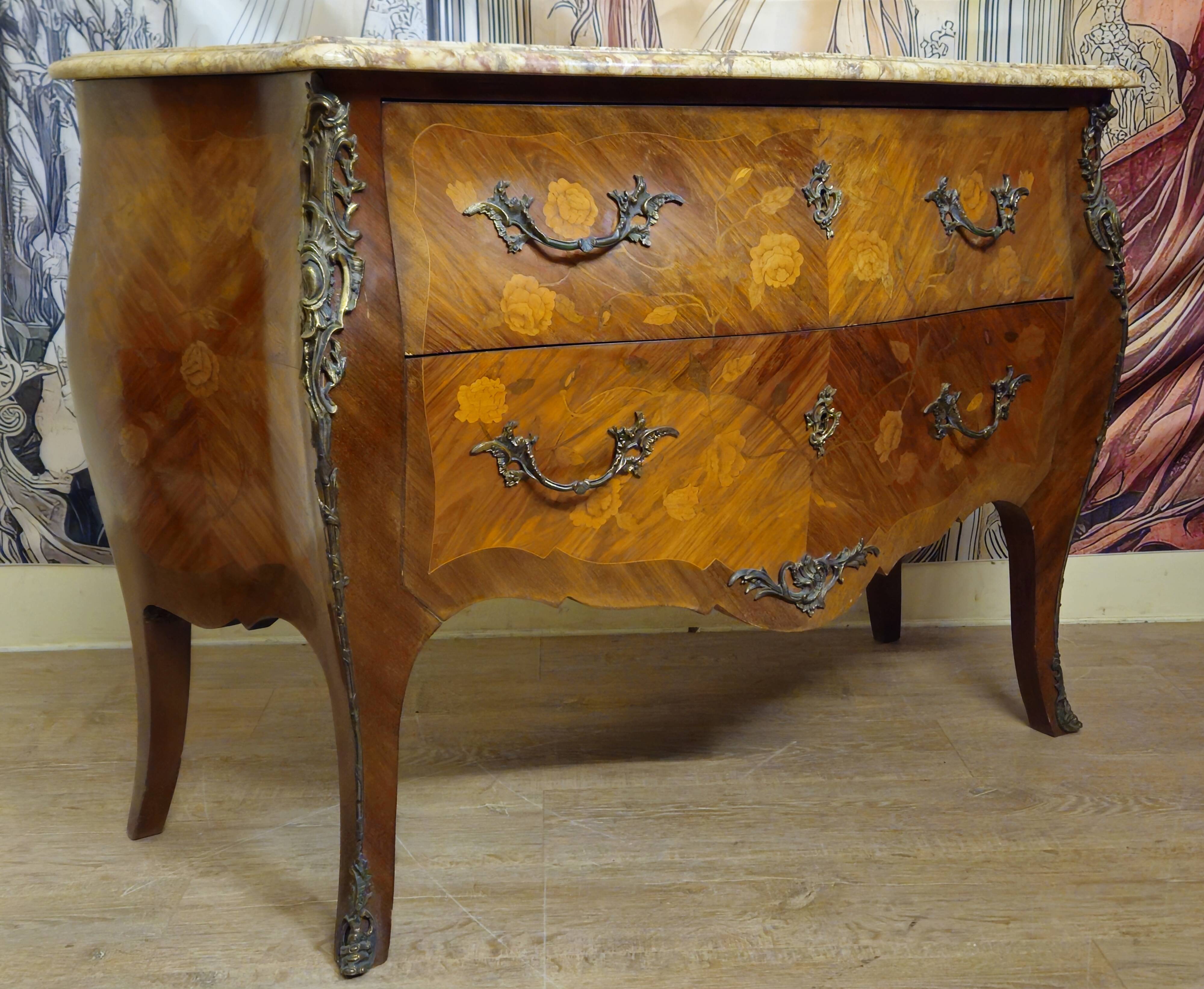 Curved Louis XV style commode with floral marquetry and marble top.
