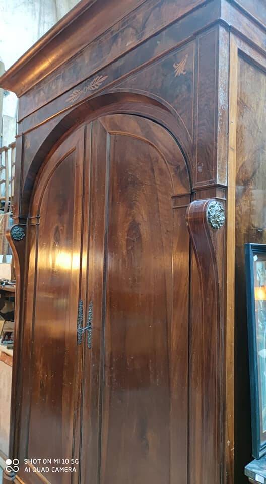 A walnut wardrobe with marquetry and boxwood stringing, dating from the Consulate period, circa 1810.