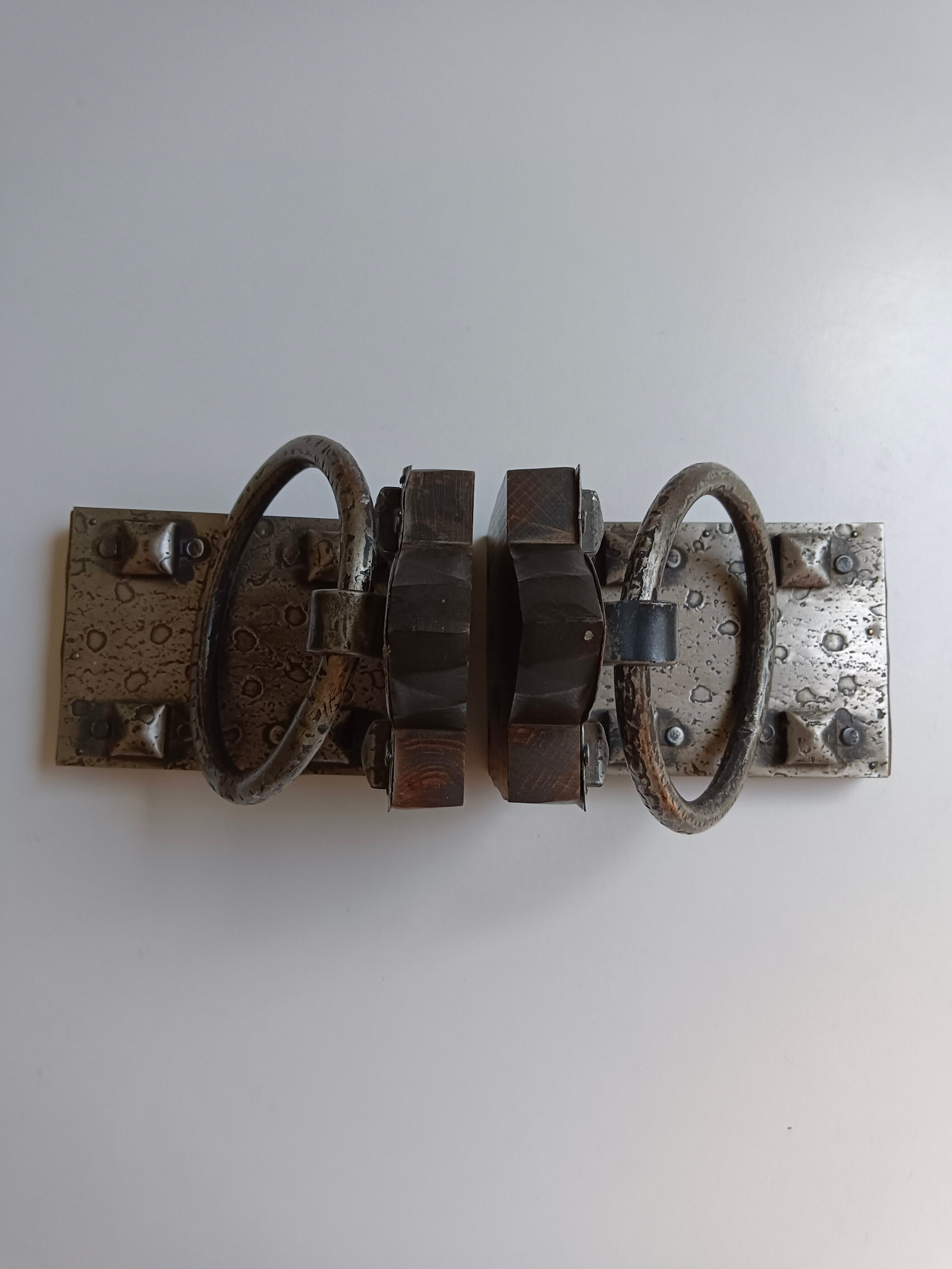 Medieval-style bookends, antique door handle.