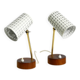 A pair of mid-century modern bedside lamps with perforated metal shades